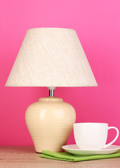 table lamp and cup on pink background