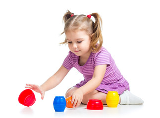Cute child girl playing with toys isolated over white