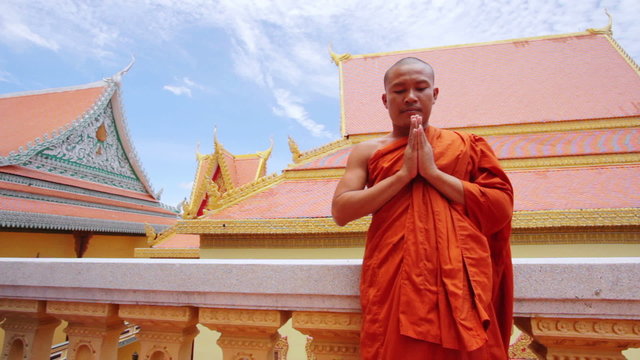 buddhist monk with orange robe pray in temple