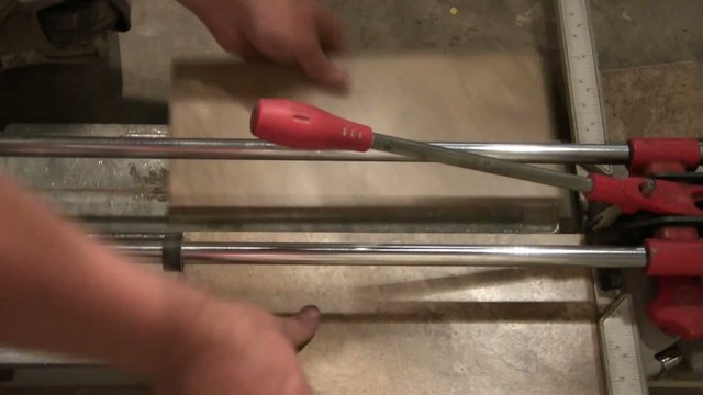 Man Cutting Tile Manually
