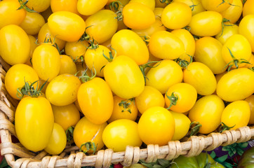 Yellow cherry tomatoes in wicker basket