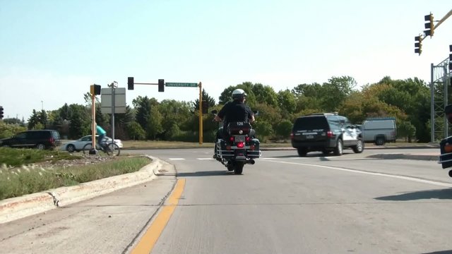 Motorcycle Cop Driving Away