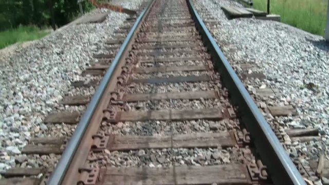 Pan up Railroad Tracks in Sun