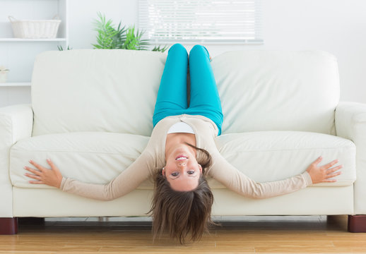 Funny Woman Lying Upside Down On Sofa