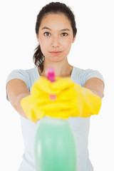 Brunette woman pointing spray bottle