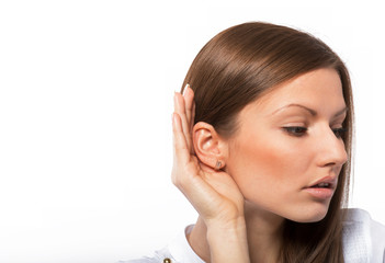 Portrait of a listening young woman, white background