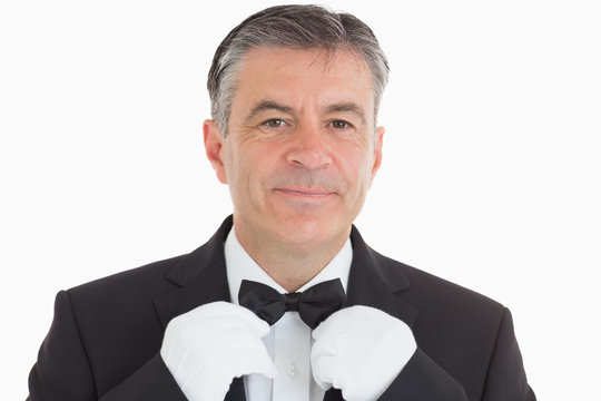 Smiling Waiter Adjusting His Bow Tie