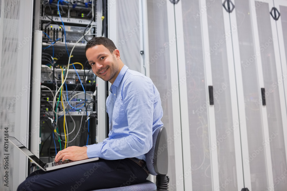 Poster smiling man working on the servers