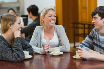 People sitting at the coffee shop smiling