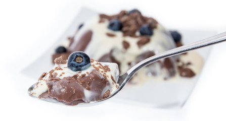 Portion of Chocolate Pudding with sauce on white