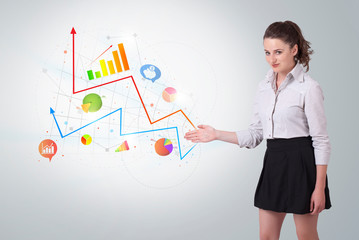 Young business woman presenting colorful charts and diagrams