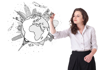 Fototapeta premium Young woman drawing a globe on whiteboard