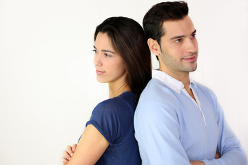 Young in love couple standing back to back