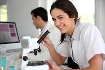 Portrait of smiling student in microbiology - Powered by Adobe