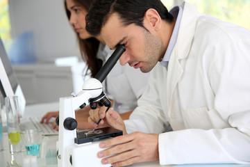 Doctor in biology working on microscope