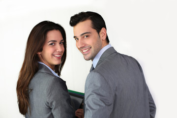 Portrait of smiling business people in grey suit