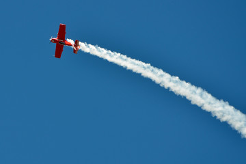 The plane on the blue sky during air show - obrazy, fototapety, plakaty