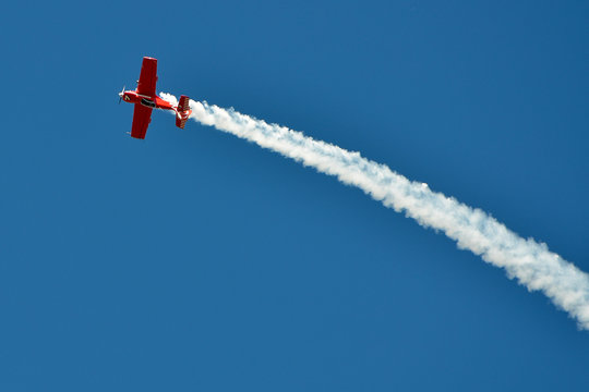 The plane on the blue sky during air show