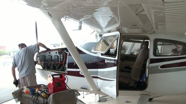 Airplane Mechanic Working on Engine