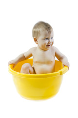 Cute baby taking bath in yellow tub