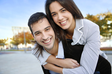 Fototapeta premium Cheerful couple standing in town on fall season
