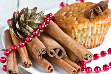 Homemade muffin with cinnamon and anise on plate.