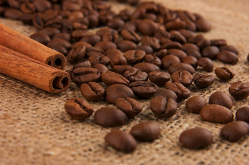 Cinnamon and coffee beans on burlap
