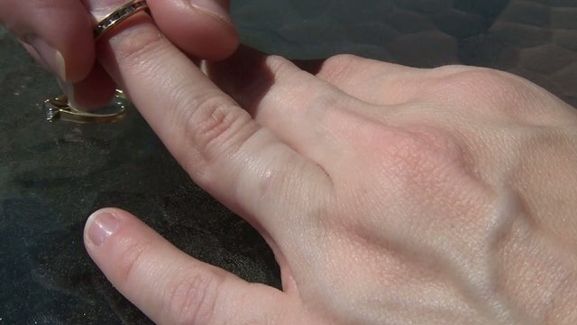 Woman Putting on Wedding Ring