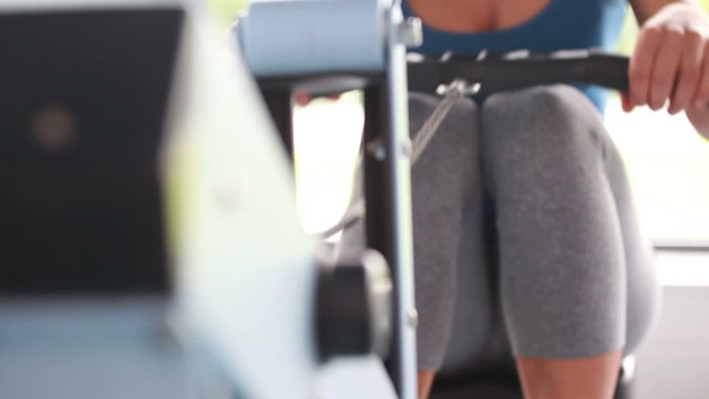 Woman drawing on row machine