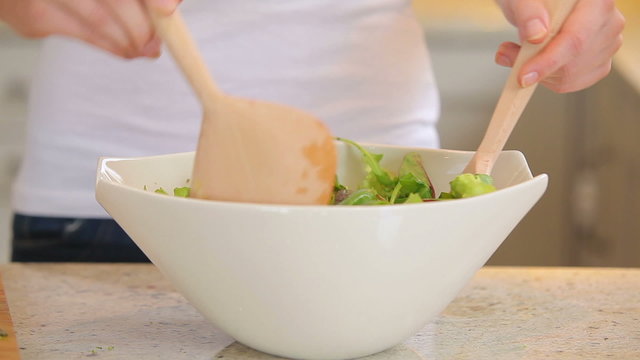 Woman tossing salad