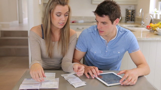 Couple calculating with tablet pc
