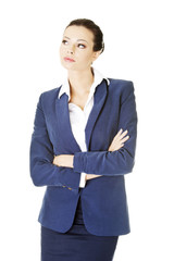 Young thoughtful businesswoman looking on side