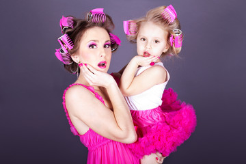 young mother with her daughter in the form of cheerful housewive