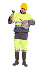 Builder hitting globe with chisel