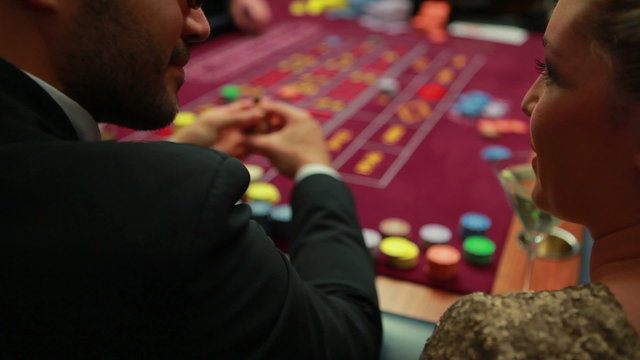 Woman talking to man at roulette table