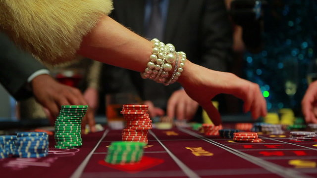 People placing their bets on roulette table