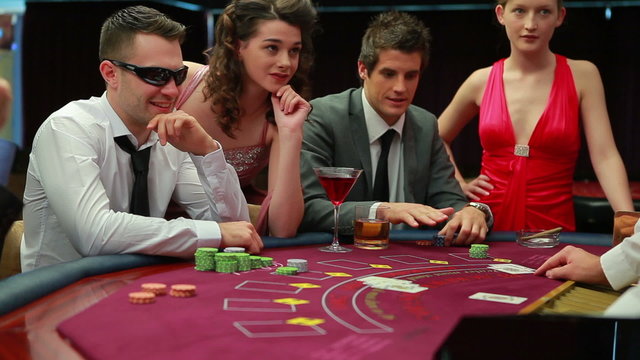 Man in sunglasses winning at blackjack