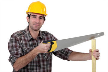 Man sawing plank of wood