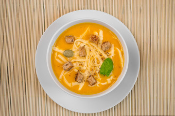 Pumpkin soup in a white plate