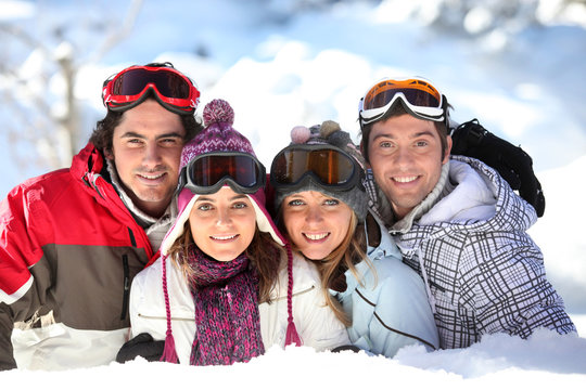 Two couples in a ski slope