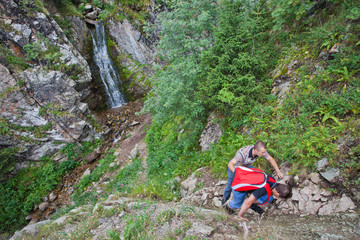 Two tourists near the waterfall