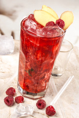 Red drink with raspberries, ginger and ice