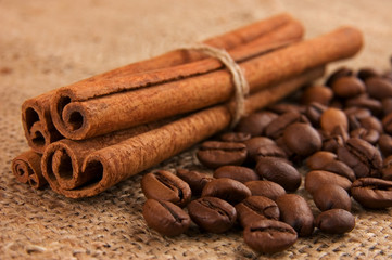 Cinnamon sticks and coffee beans on burlap
