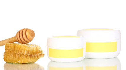 Jars of cream with honey isolated on white