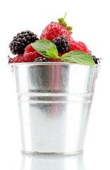 beautiful berries with leaves in bucket isolated on white