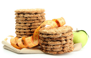 tasty crispbread, apple and measuring tape, isolated on white