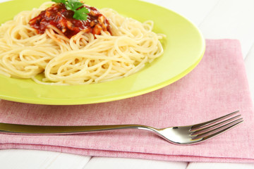 Italian spaghetti in plate on wooden table