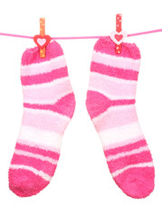 Pair of striped socks hanging on a rope isolated on white