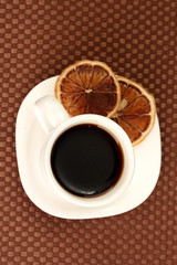 Cup of coffee on brown background