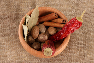 Nutmeg and other spices on sackcloth background